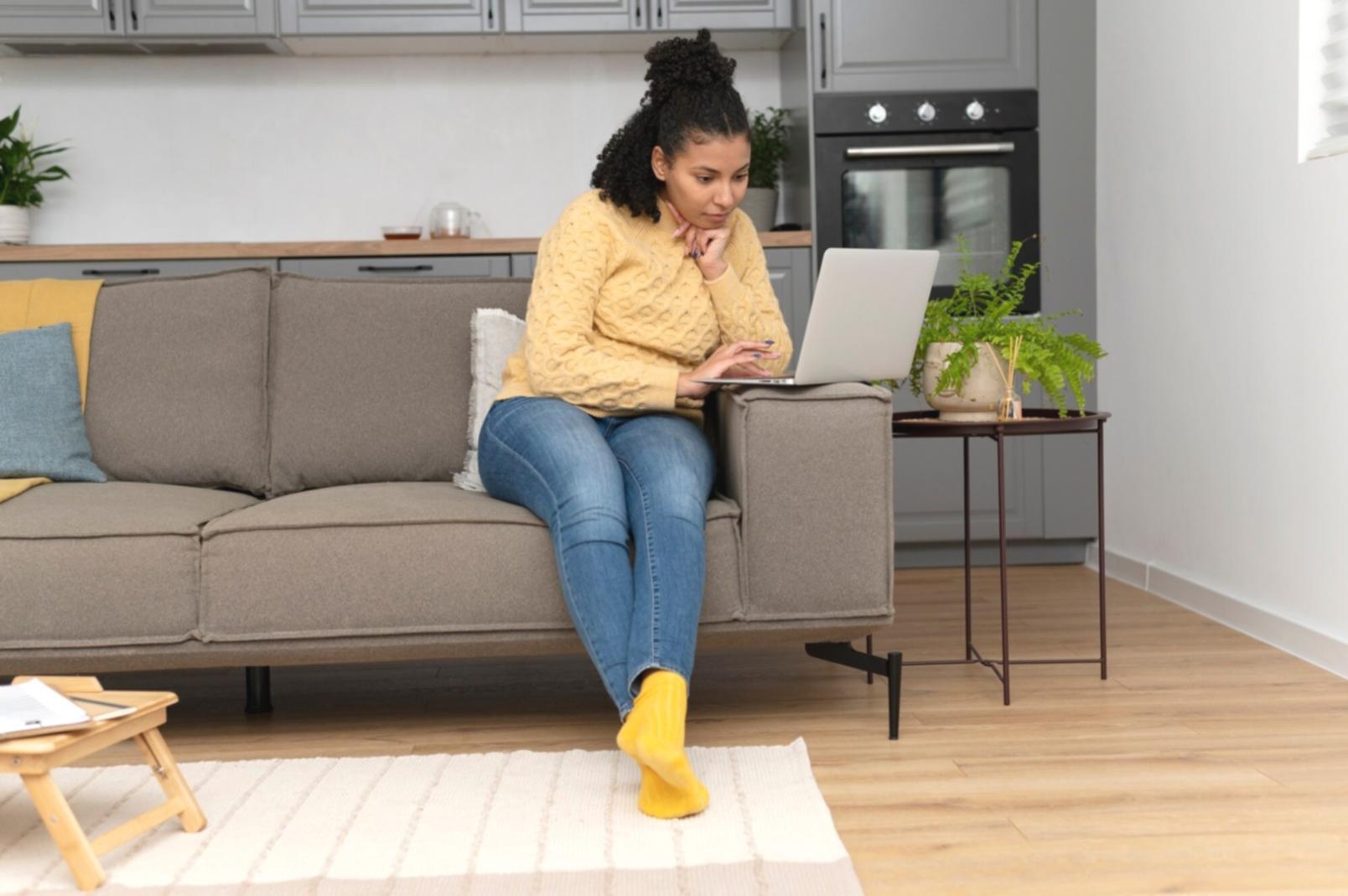 Person organizing bills and receipts on desk with calculator